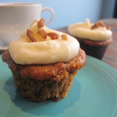 A picture of carrot cupcake with cream cheese frosting.